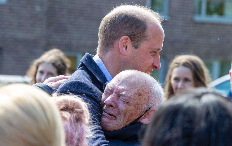 Prince William hugs pensioner