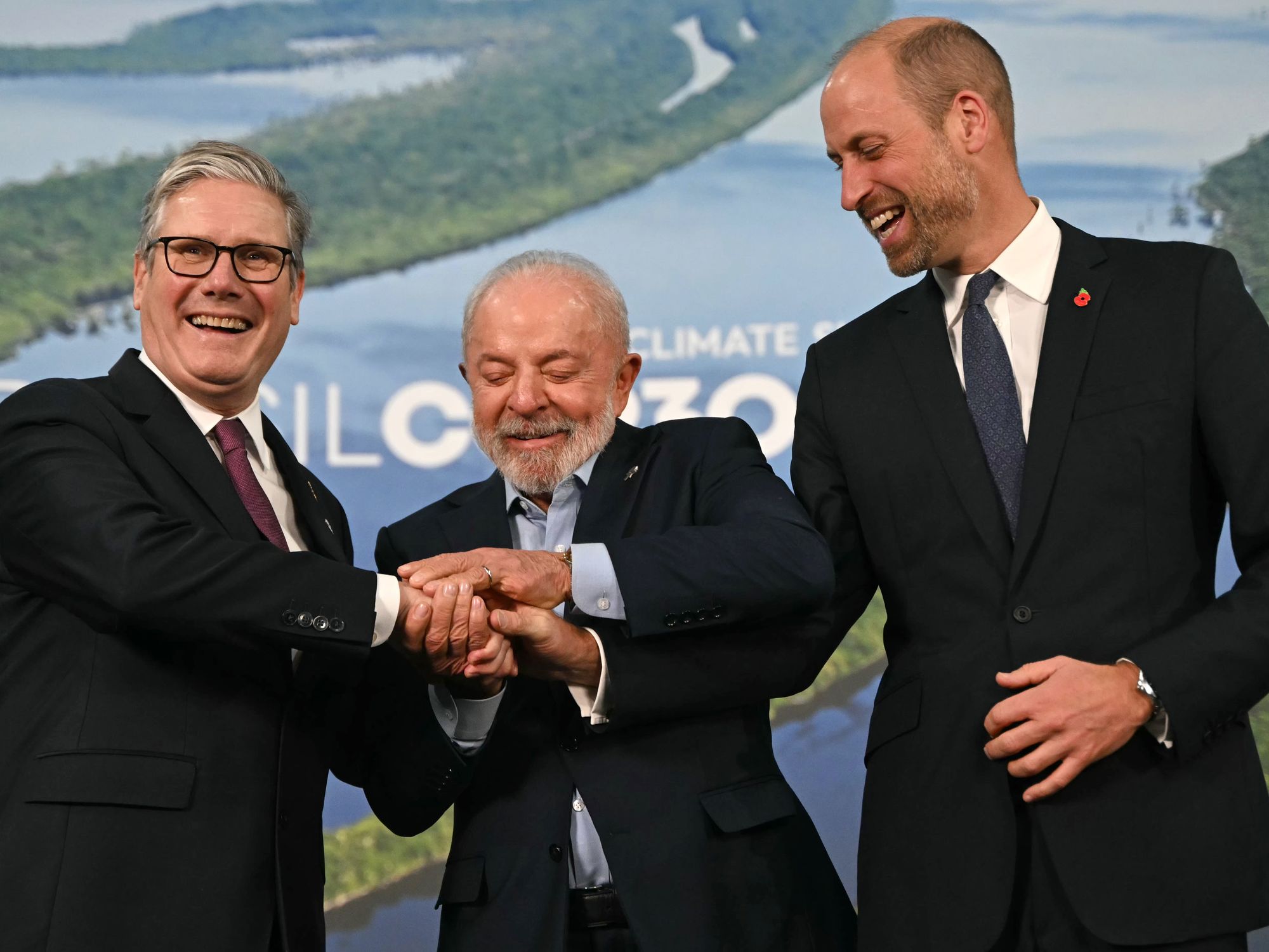 PICTURED: Prince William caught in awkward moment with Keir Starmer in 'forced three-way handshake'