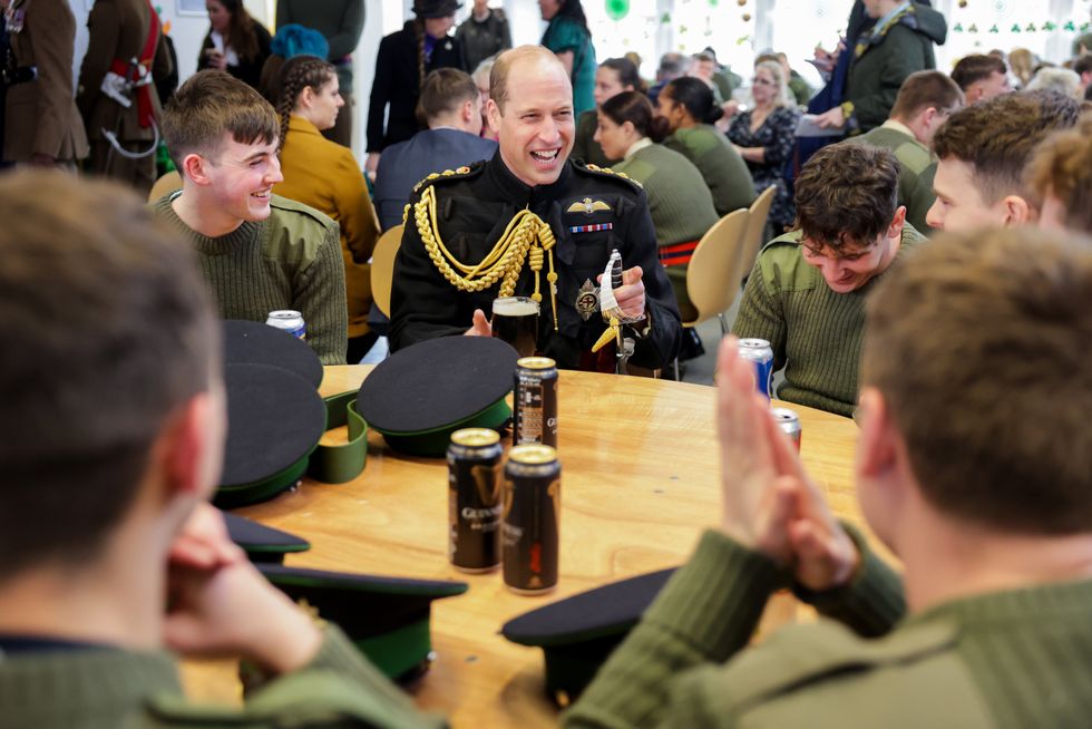 Prince William sitting at table with troops