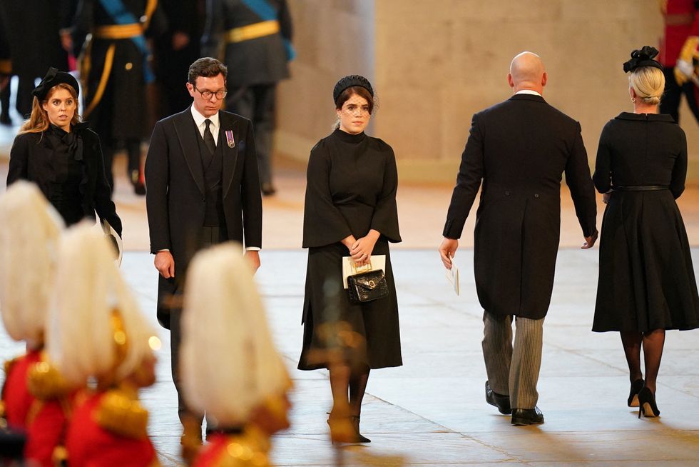 Princess Beatrice, Jack Brooksbank and Princess Eugenie look on as the coffin of Queen Elizabeth II lies on the catafalque in Westminster Hall, London, where it will lie in state ahead of her funeral on Monday. Picture date: Wednesday September 14, 2022. Jacob King/Pool via REUTERS