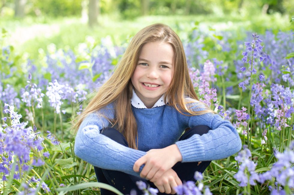 Princess Charlotte is seen in a cable knit blue jumper.