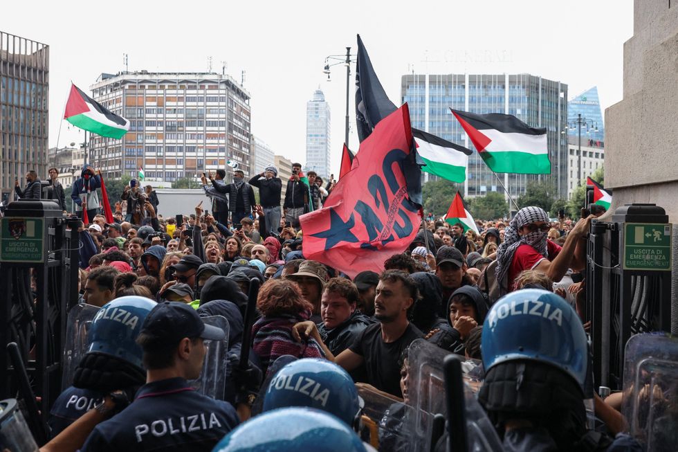 Pro-Gaza demonstrators attempt to barge through the front gates to Milan's railway station