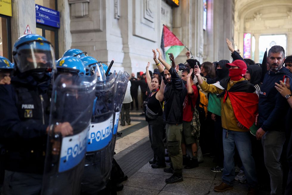 Pro-Palestine demonstrators line up against police in Milano Centrale station