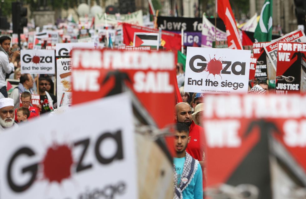 Pro-Palestine demonstrators march along Whitehall, in Westminster, London, as they march to the Israeli embassy