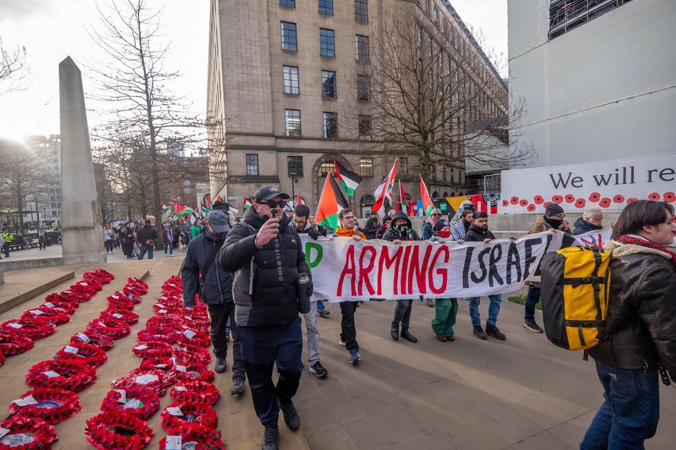 Pro-Palestine protesters march over a Remembrance display in Manchester\u200b