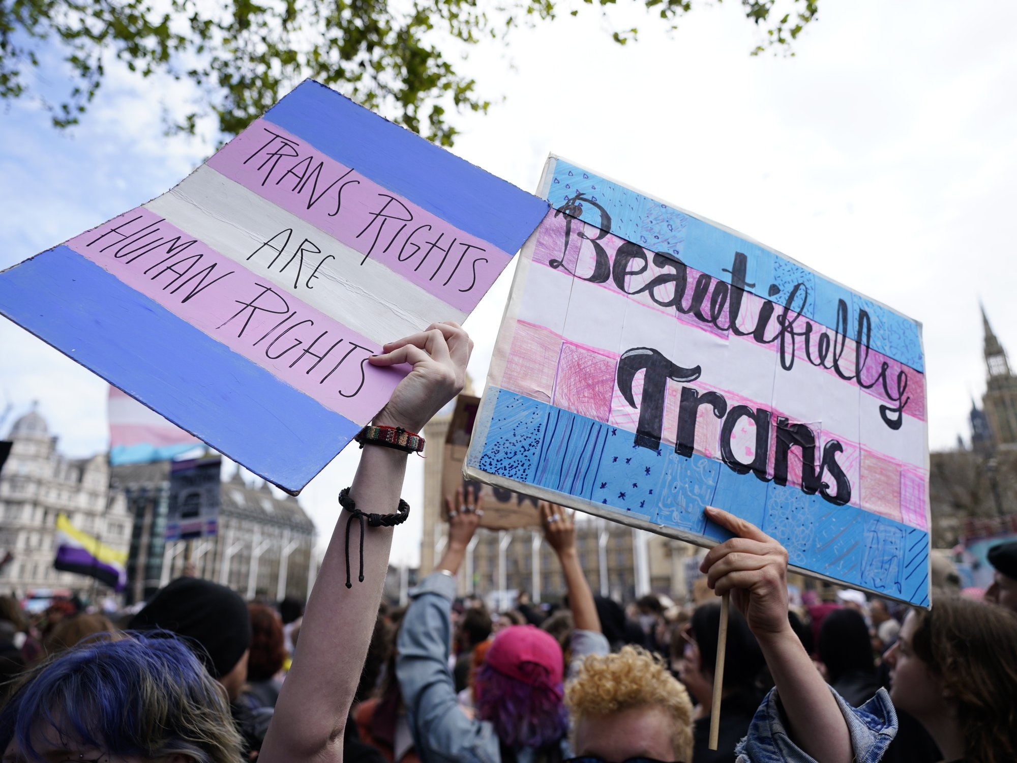 Pro-trans protesters gather outside the Supreme Court