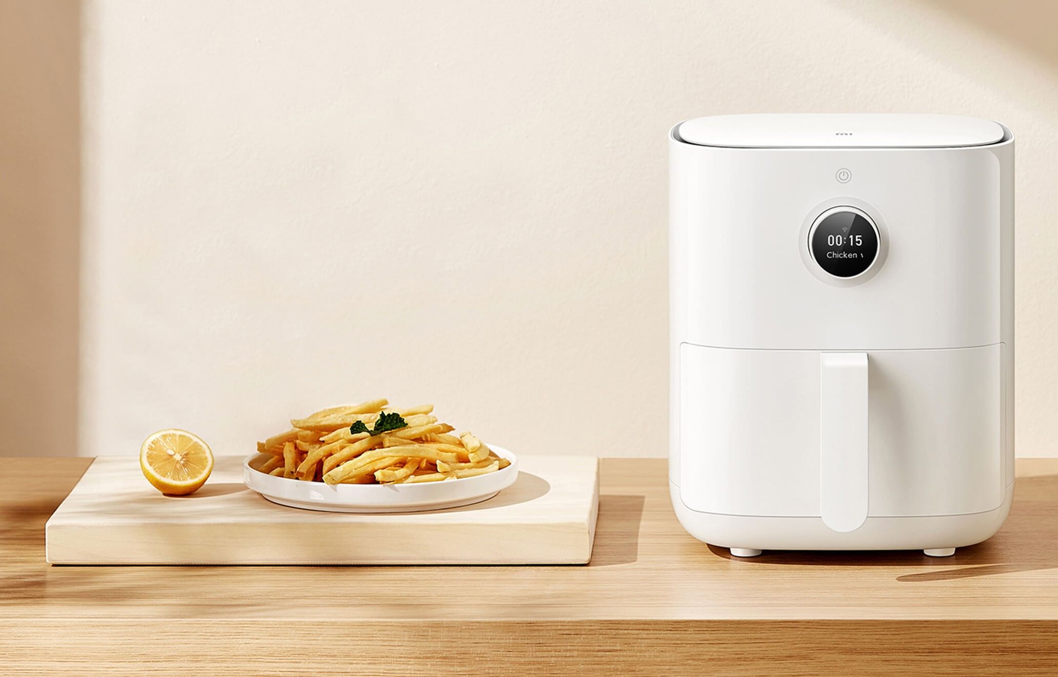 promotional image of the xiaomi mi smart air fryer next to a plate of chips