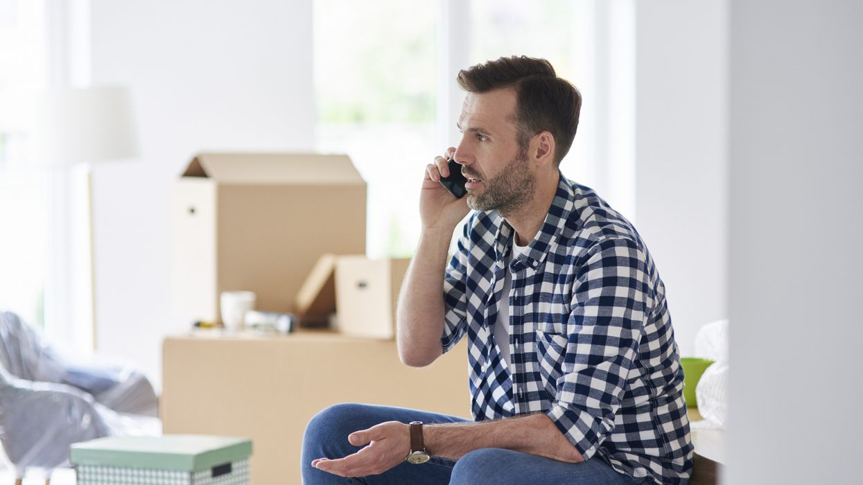 Property buyer looks worried on phone