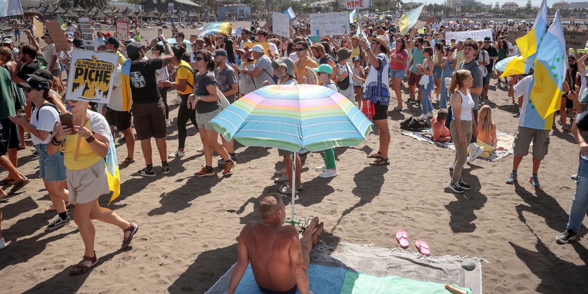 NextImg:'Tourists go home!' Terrified beach-goers mobbed by hundreds of protesters in Tenerife