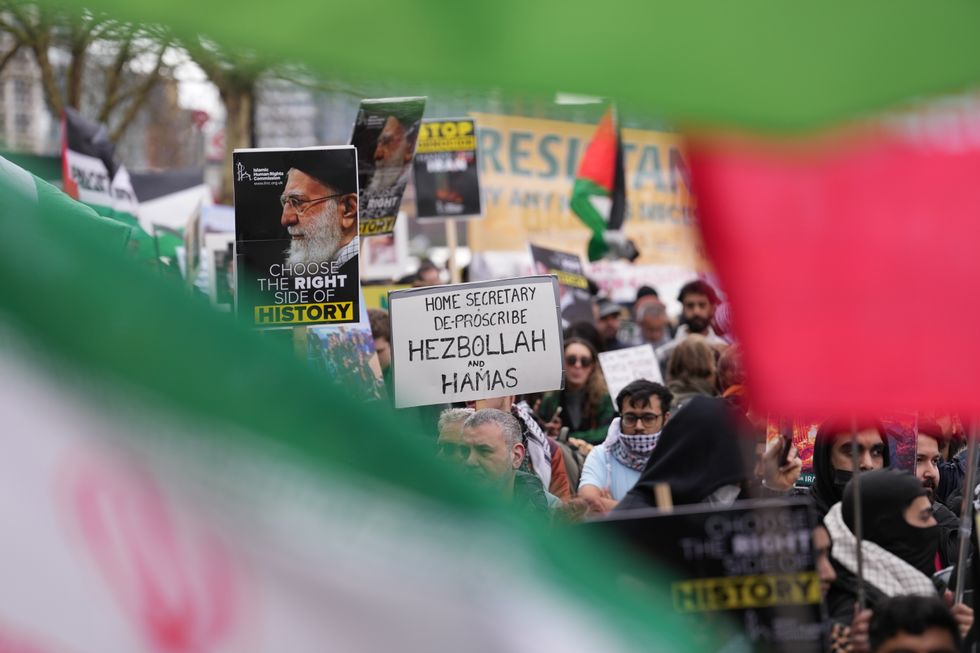 Protester holding up sign saying 'Home Secretary de-proscribe Hezbollah and Hamas'