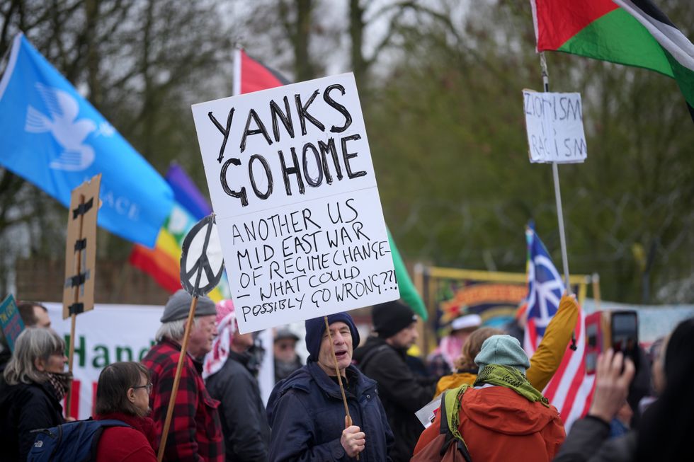 Protester holding up 'yanks go home' placard