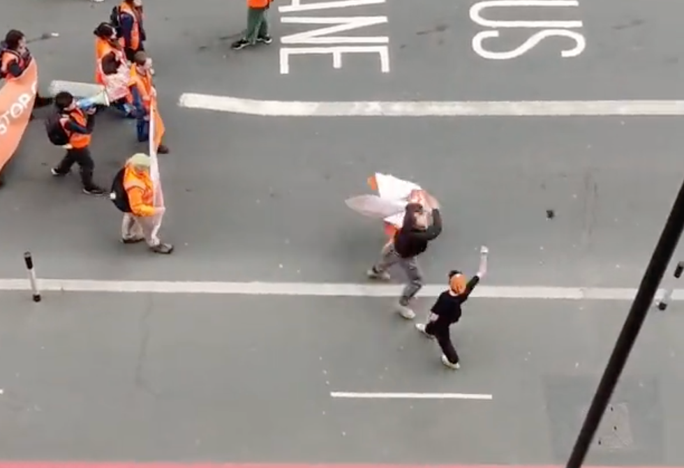 Protester's phone being smacked into the air