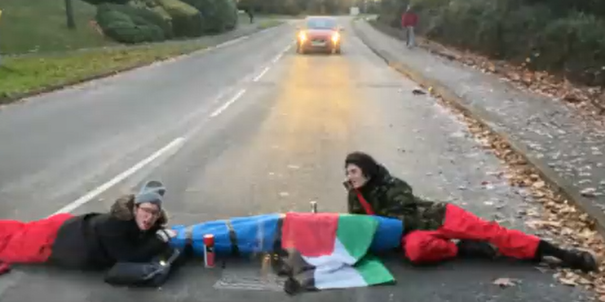 NextImg:Palestine protesters lock together to block road in Leicester as factory workers barred from going to work