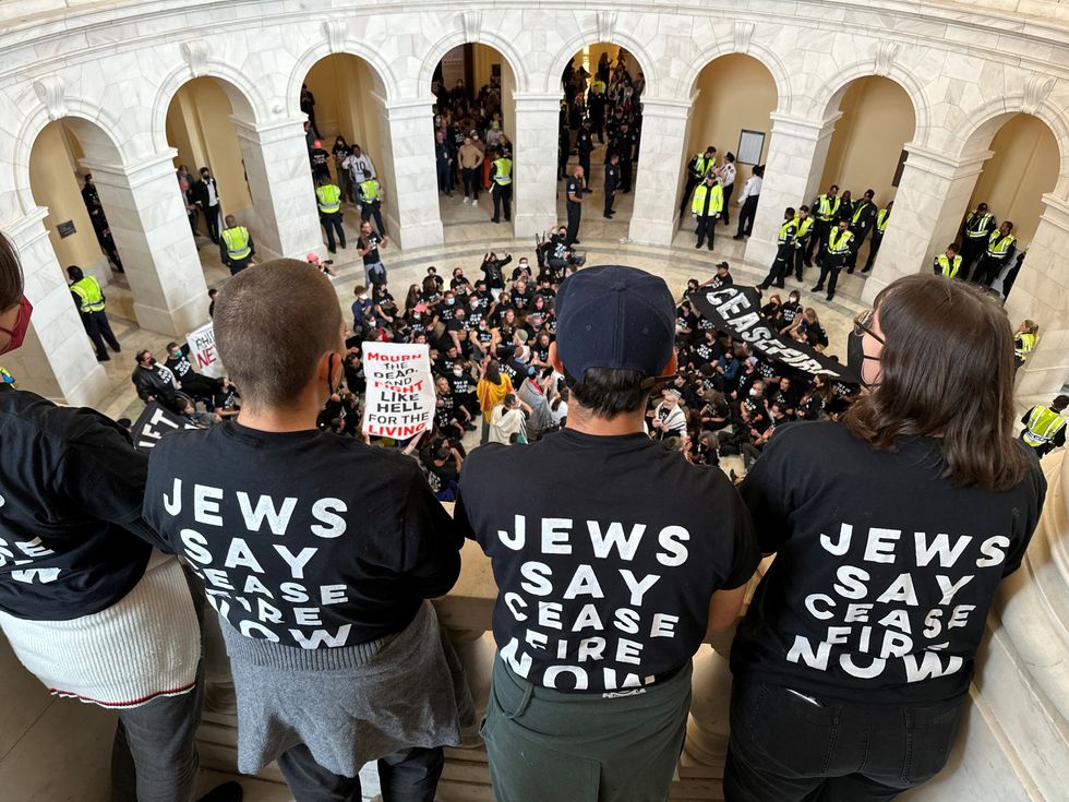Protesters calling for a cease fire in Gaza and an end to the Israel-Hamas conflict look down on fellow protestors