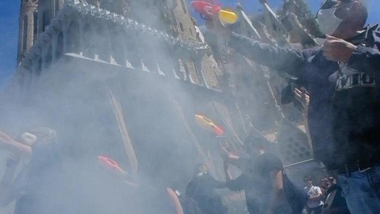 'Tourists go home!' Anti-tourist protesters SWARM tour bus and fire water pistols at holidaymakers