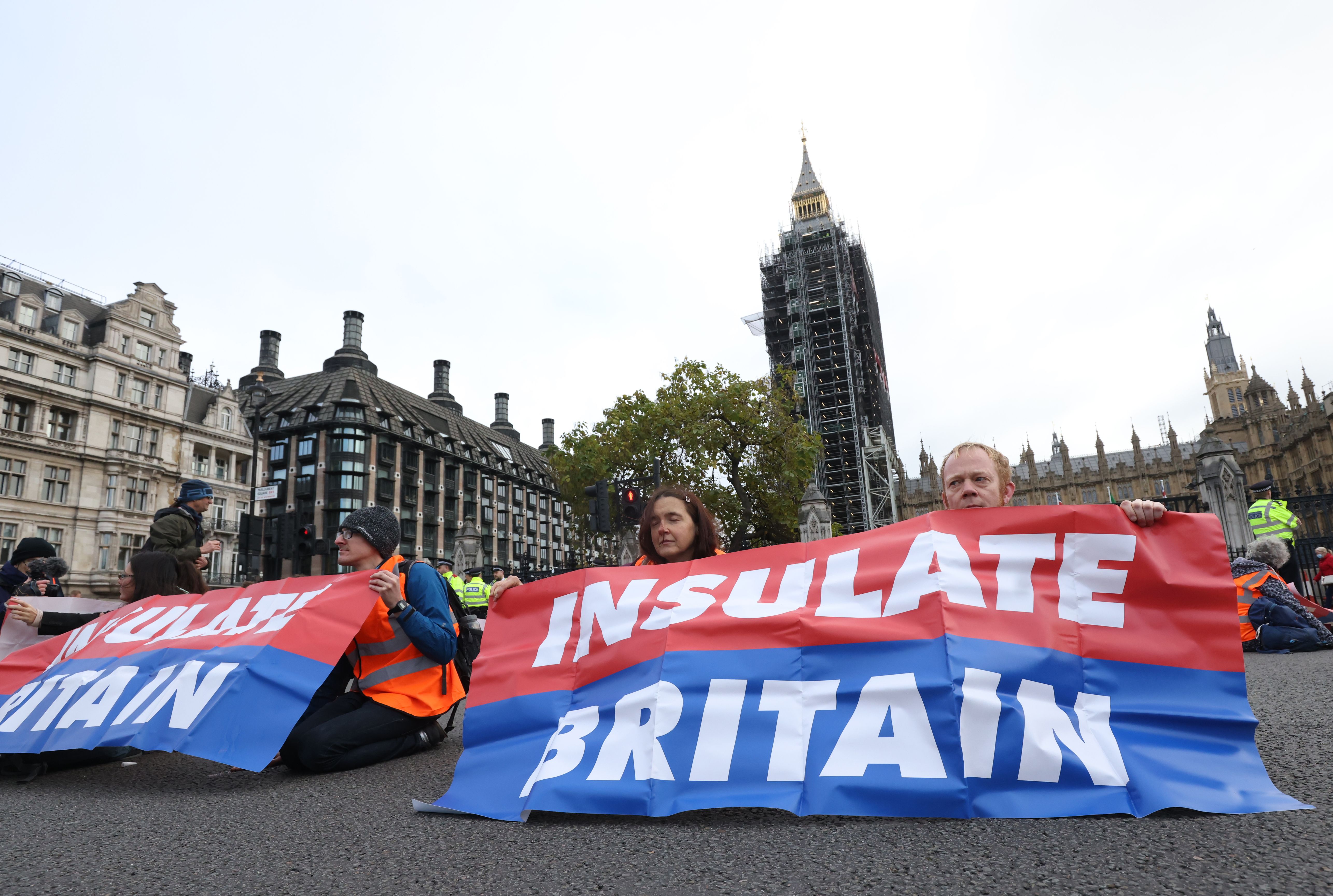 Protesters from Insulate Britain block Great George Street in Parliament Square, central London
