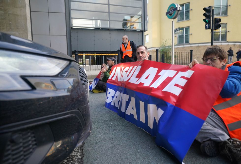 Protesters from Insulate Britain blocking a road near Canary Wharf in east London.