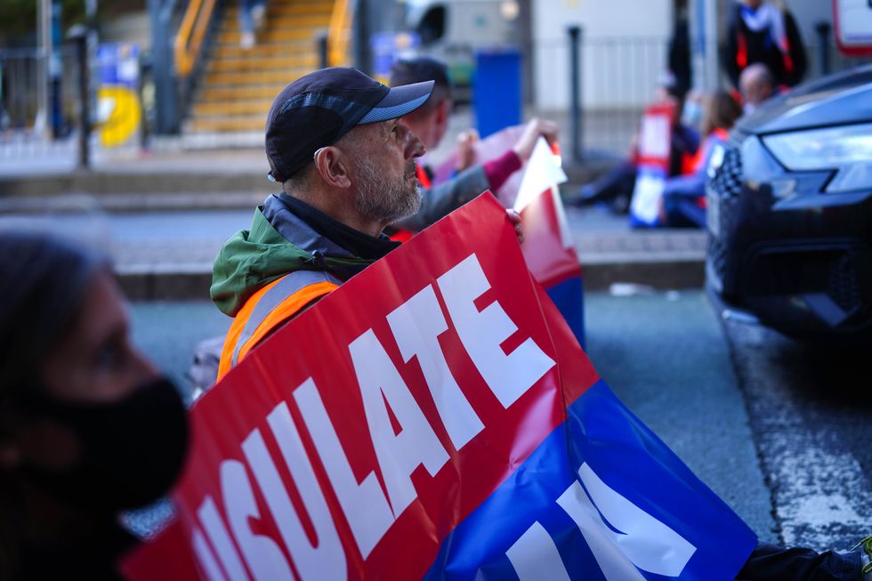 Protesters from Insulate Britain blocking a road near Canary Wharf in east London.