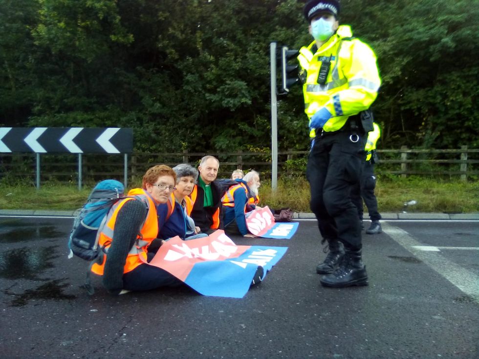 Protesters from Insulate Britain blocking a roundabout at Junction 3 of the M25.