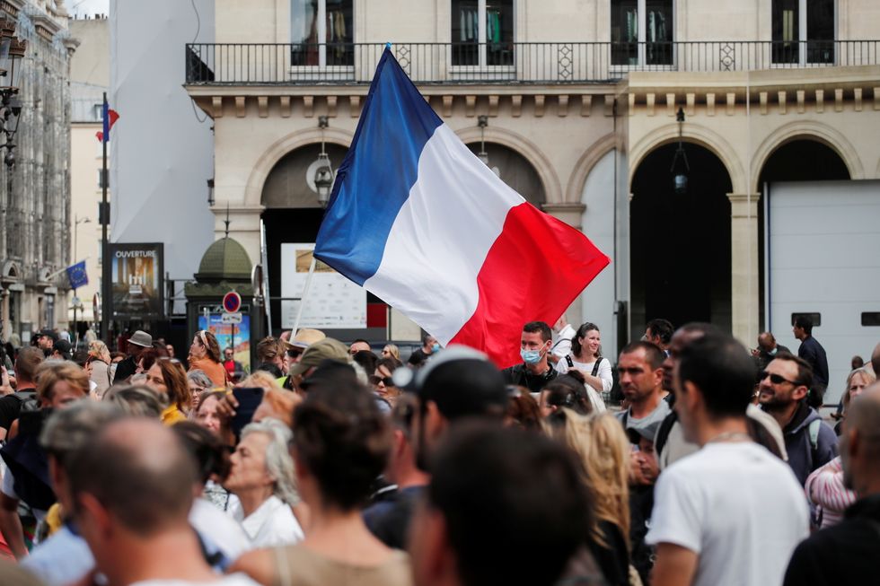 Protesters hold a French flag during a demonstration called by the 'yellow vests'