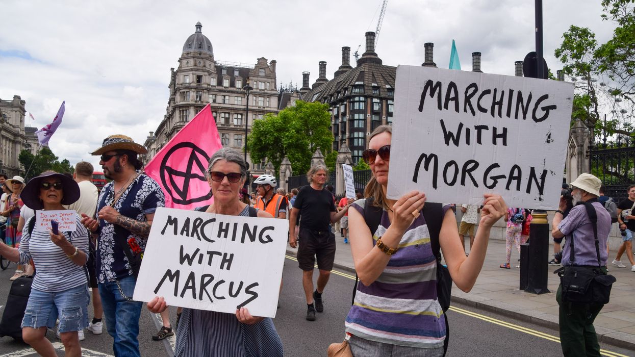 Protesters hold 'Marching with Marcus and Morgan' placards during the demonstration