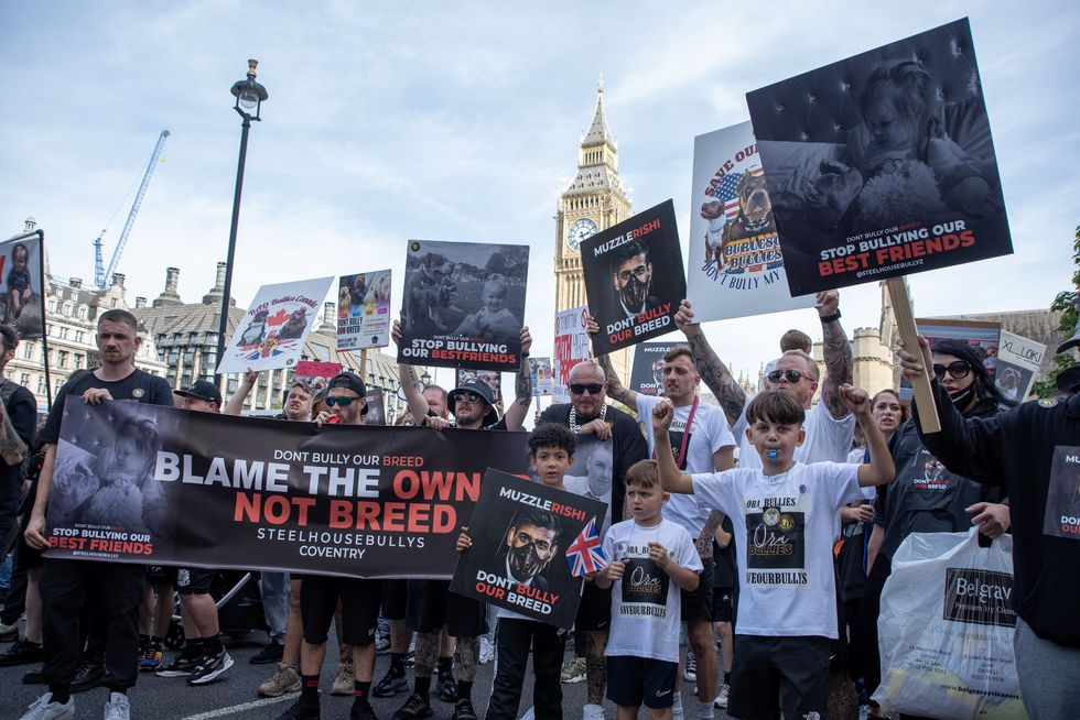 Protesters hold placards and a banner expressing their opinion during the demonstration