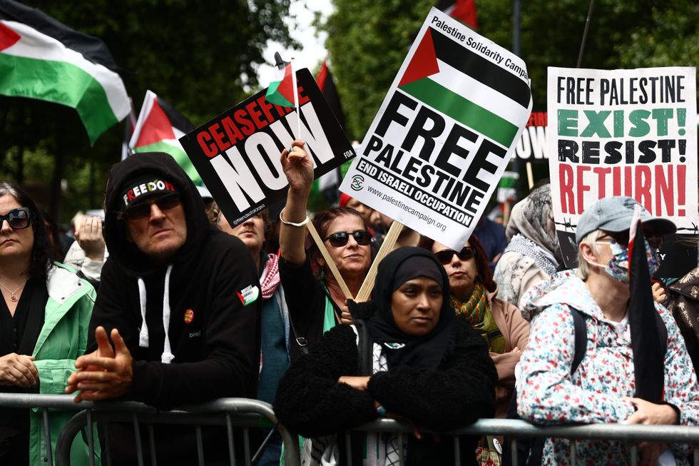 Protesters hold up a 'free Palestine' sign sponsored by the PSC
