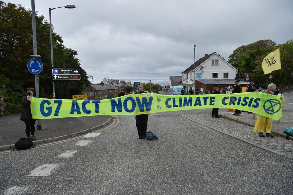 Protesters holding a banner on an XR Protest from St Ives Leisure Centre to St Ives, during the G7 summit in Cornwall.