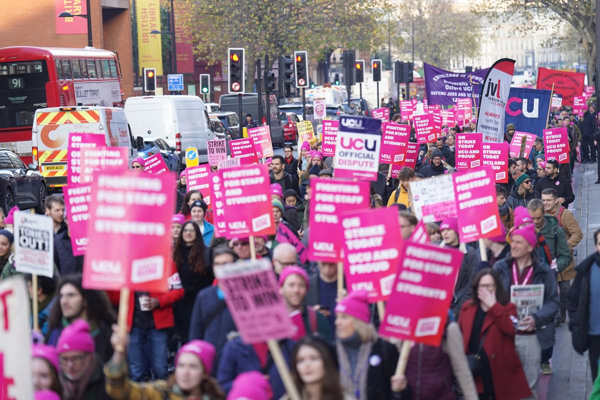 Protesters marching during a rally as members of the University and College Union (UCU) strike