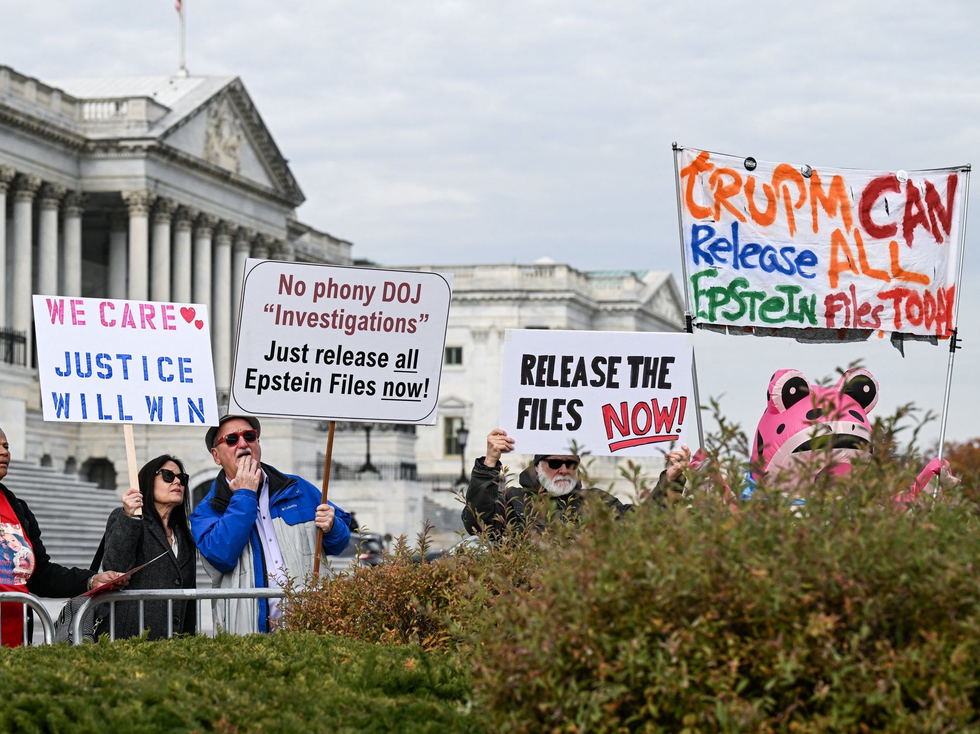 Protesters stand behind the barricades