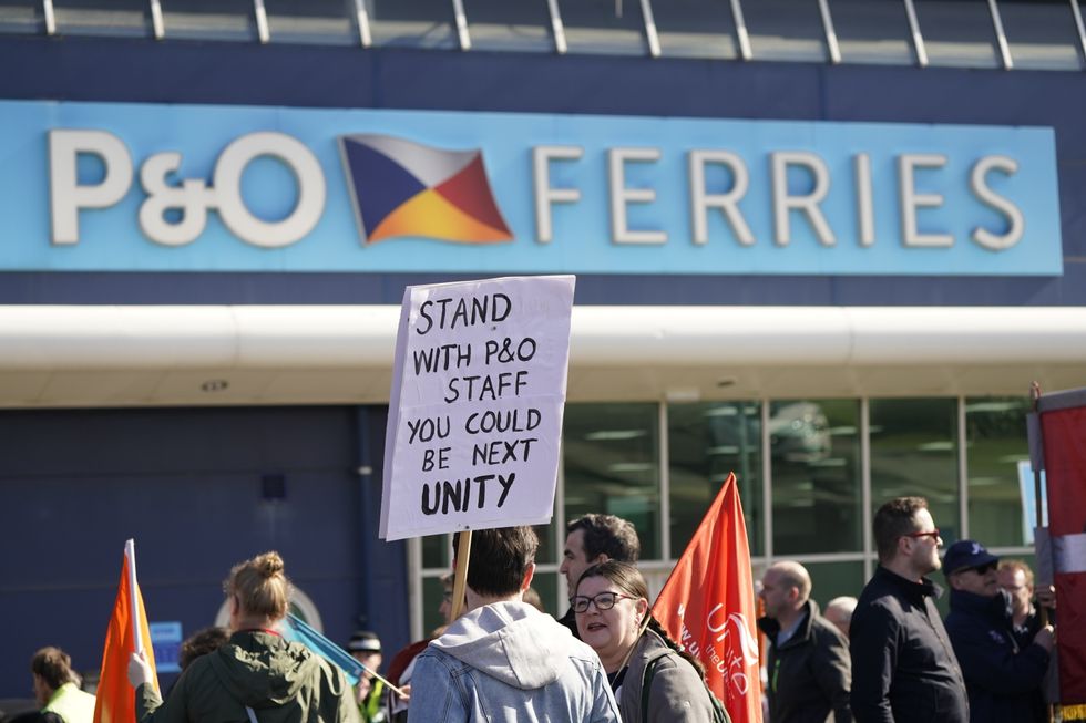 Protesters stand outside the P&O building at the Port of Hull, East Yorkshire, after P&O Ferries suspended sailings and handed 800 seafarers immediate severance notices. Picture date: Friday March 18, 2022.
