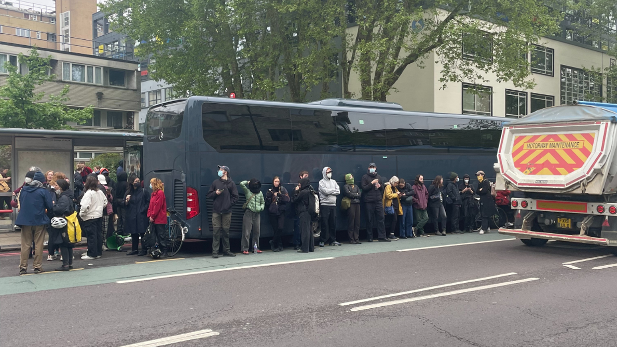 Protesters surrounding coach