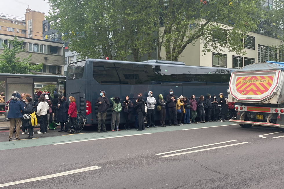 Protesters surrounding coach