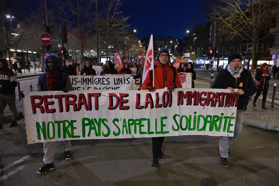 Protesters take part in a rally against France's controversial immigration bill, in Rennes, western France, on January 26, 2024