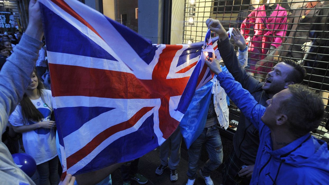 Protesters trying to burn a Union Jack
