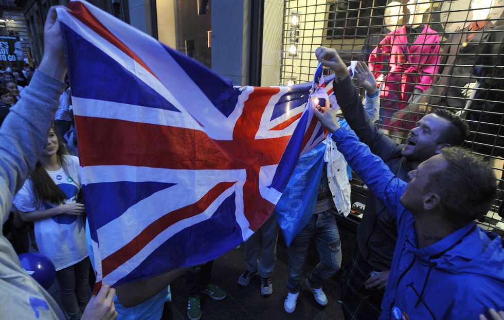 Protesters trying to burn a Union Jack