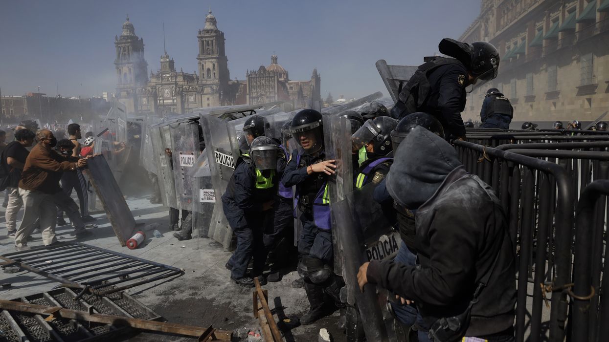 Protestors clash with riot police in Mexico City