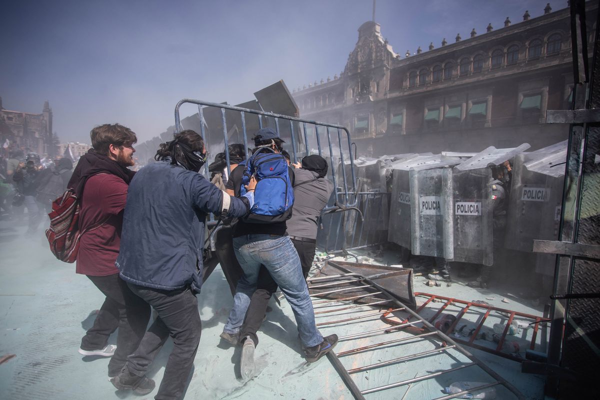 Protestors clash with riot police in Mexico City