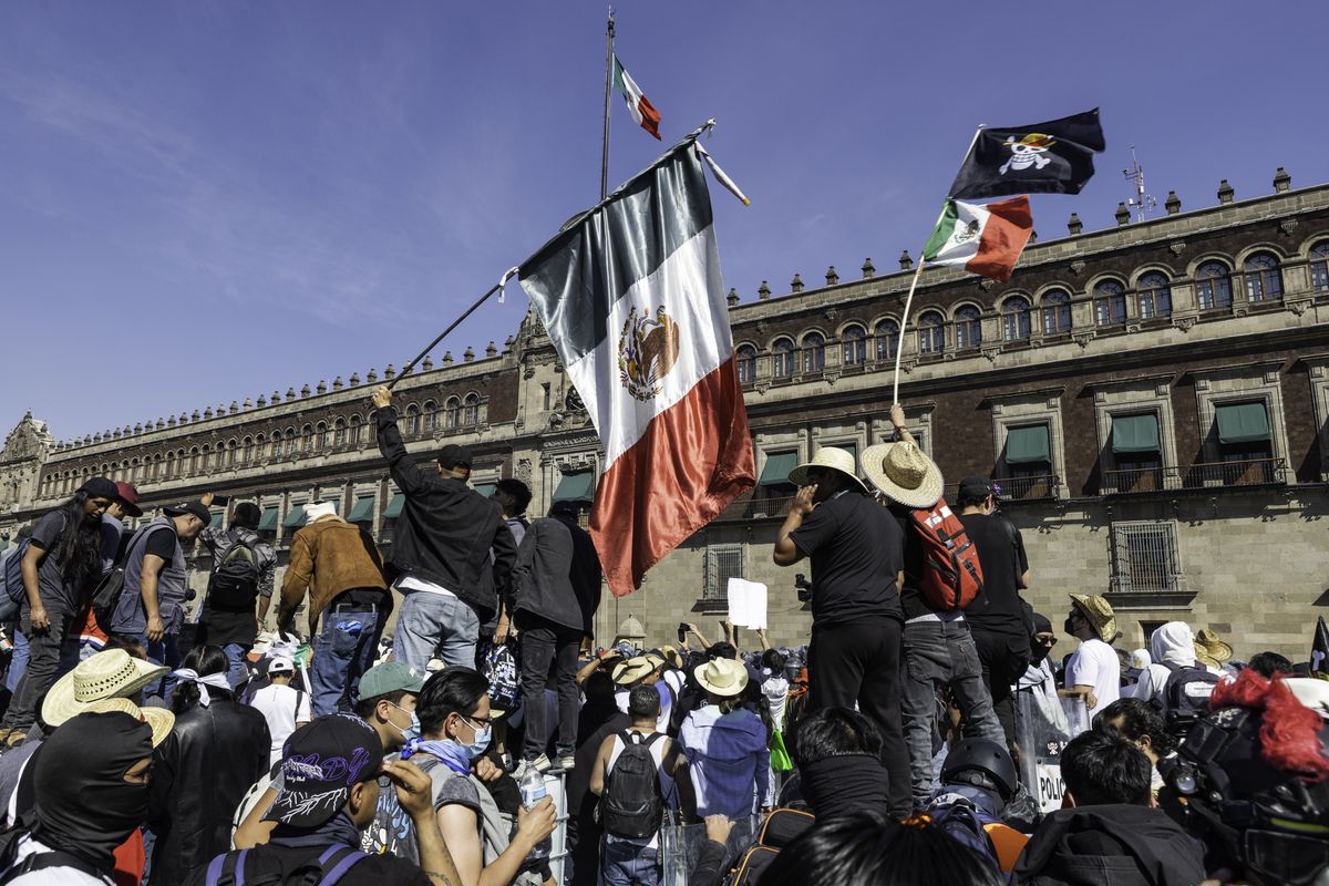 Protestors fly the Mexican flag