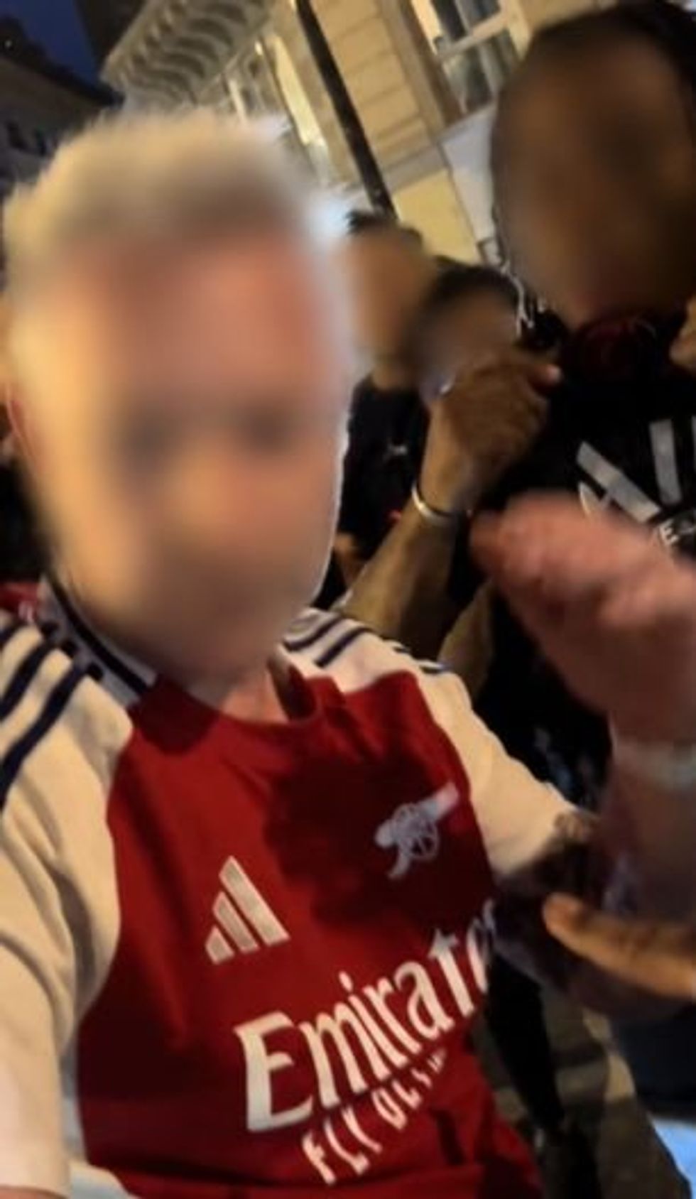PSG fans mobbed a lone Arsenal fan in the street after Saturday's Champions League final