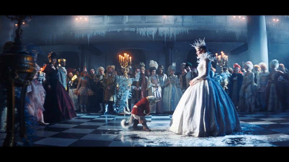 Puss presenting the Snow Queen with a Christmas gift at the ball