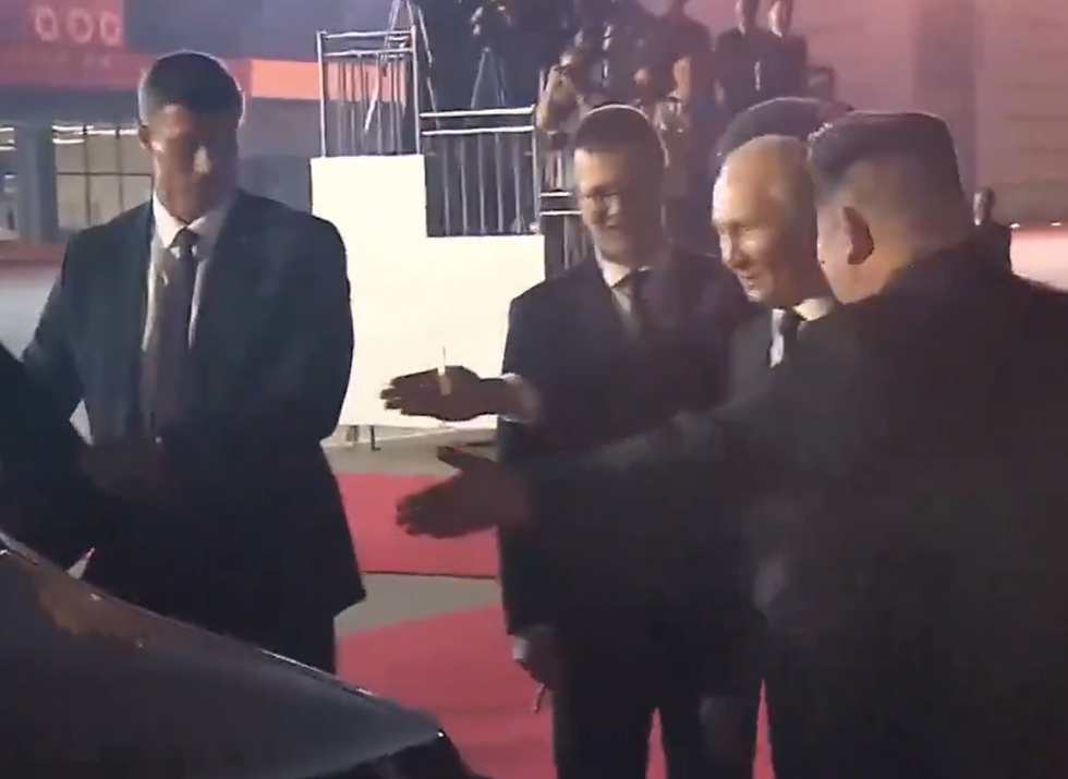 Putin and Kim deciding who should get in the car first