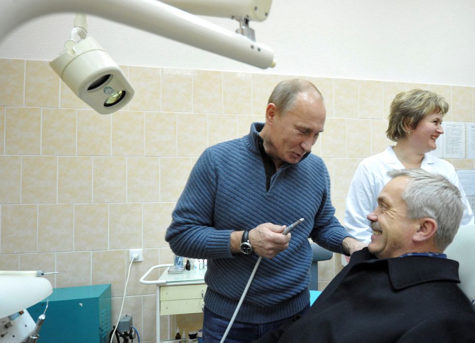 Putin holds a dental borer as he jokes with Governor of Savchenko