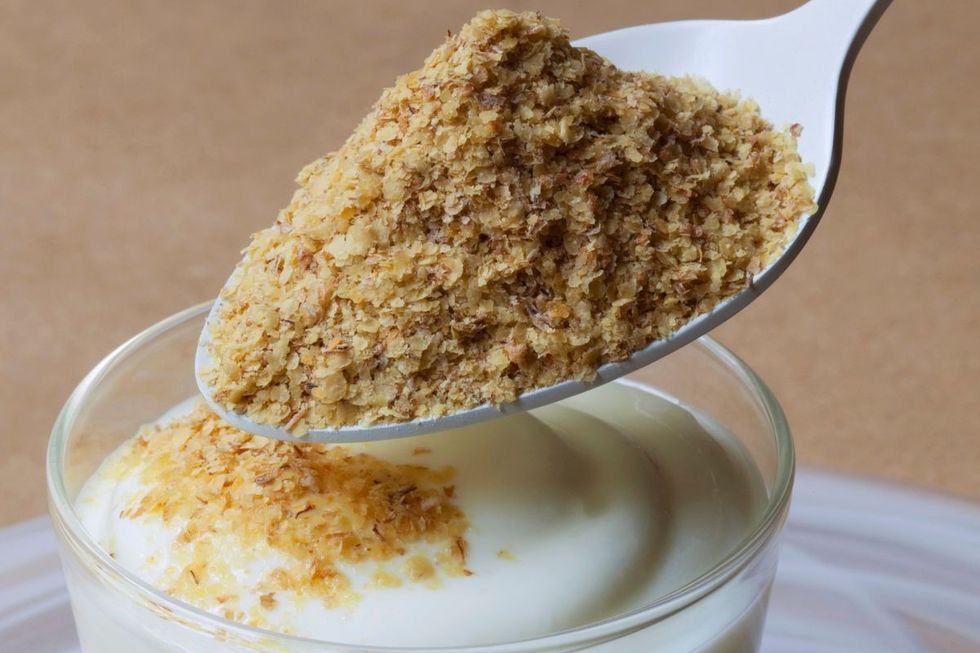 PUTTING WHEATGERM ON YOGHURT