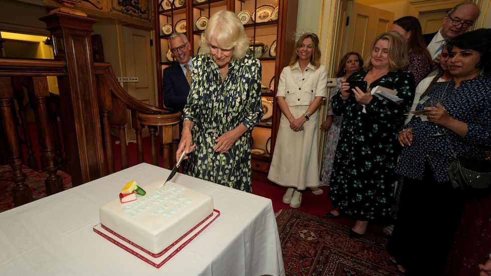 Queen Camilla cutting a cake
