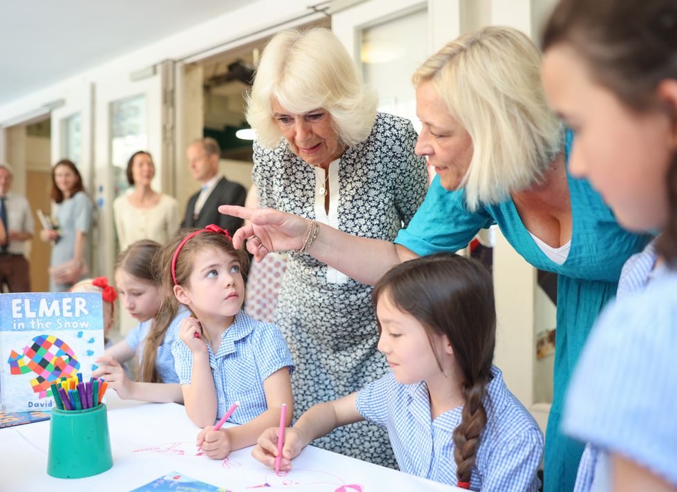 Queen Camilla looks at schoolchildren's work