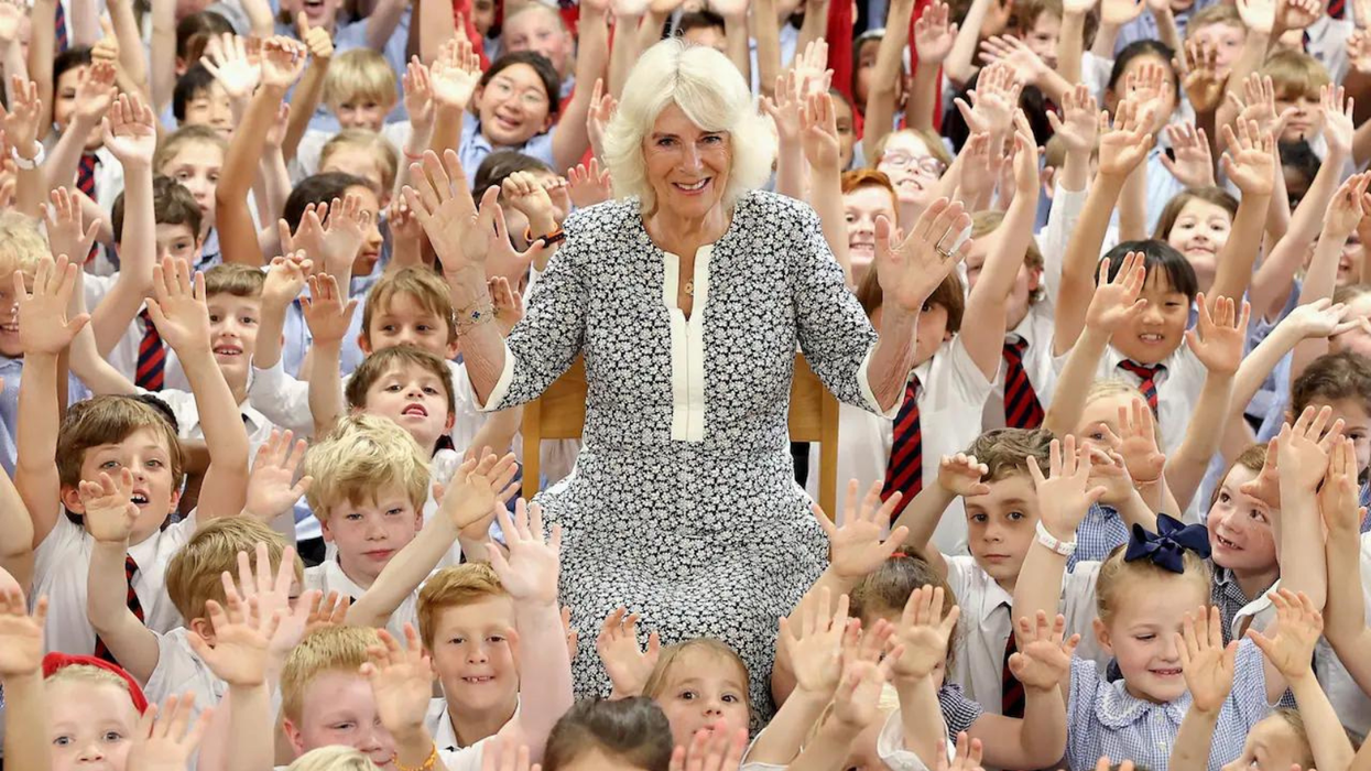Queen Camilla poses with schoolchildren