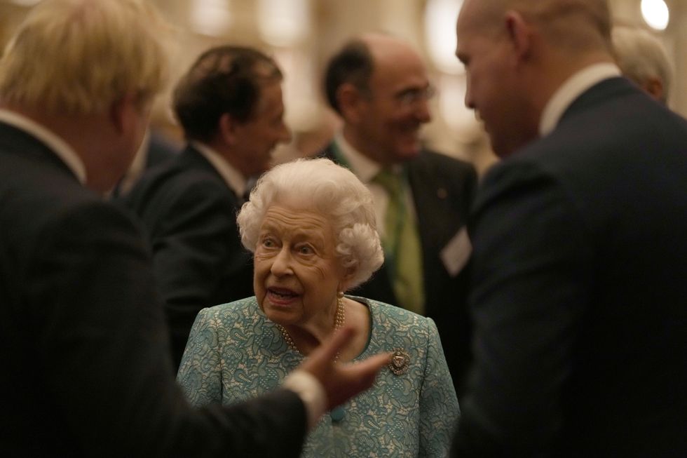 Queen Elizabeth II and Prime Minister Boris Johnson (left) meet attendees during a reception for delegates of the Global Investment Conference at Windsor Castle. Picture date: Tuesday October 19, 2021.
