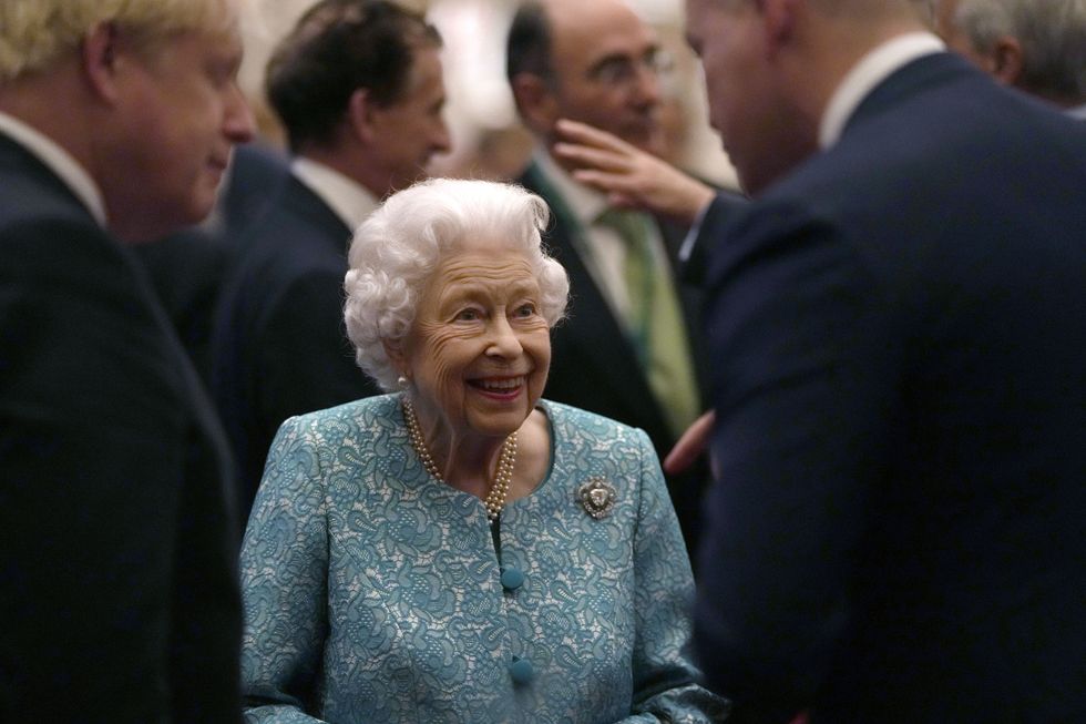 Queen Elizabeth II and Prime Minister Boris Johnson (left) meet attendees during a reception for delegates of the Global Investment Conference at Windsor Castle. Picture date: Tuesday October 19, 2021.