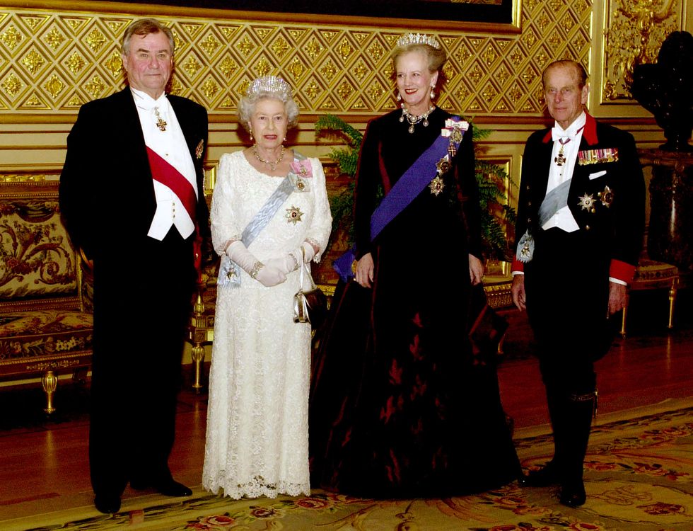 Queen Elizabeth II and Queen Margrethe of Denmark, with Prince Philip, Duke of Edinburgh and Prince Henrik pose before the state banquet at St George's Hall in Windsor Castle on February 16, 2000 in Windsor, England